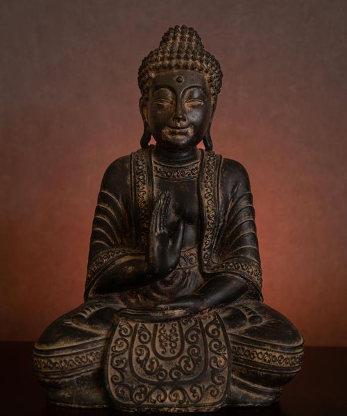 Abstract glowing sculpture resembling a human in yoga pose